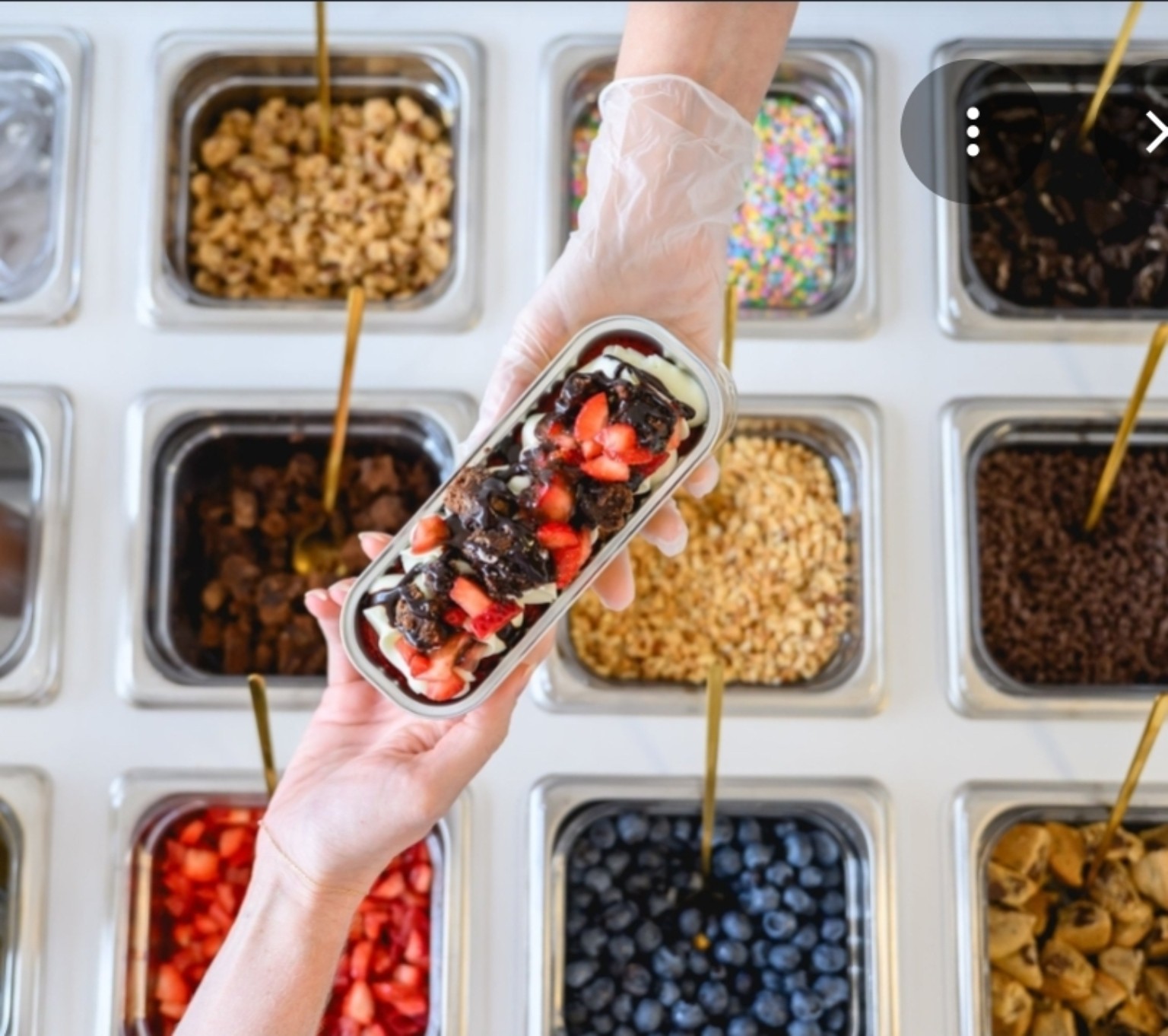 Guest building a cake with toppings at the interactive dessert cart